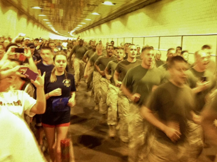 a group of people dressed in uniforms walking in an enclosed room