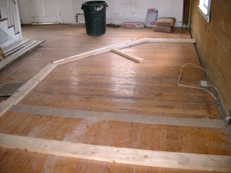 a living room being remodeled with wood floors