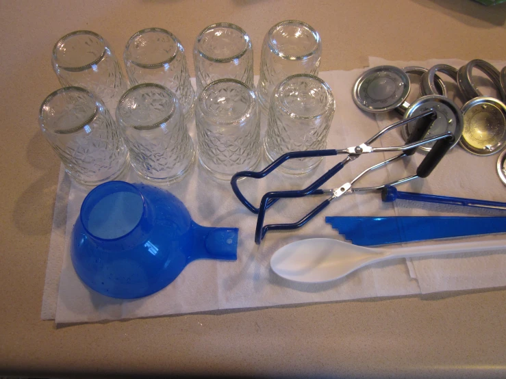 a table is filled with glassware and kitchen utensils