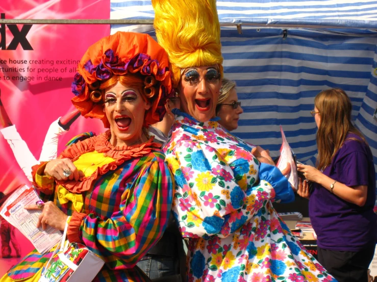 a woman with painted hair wearing a multi colored wig