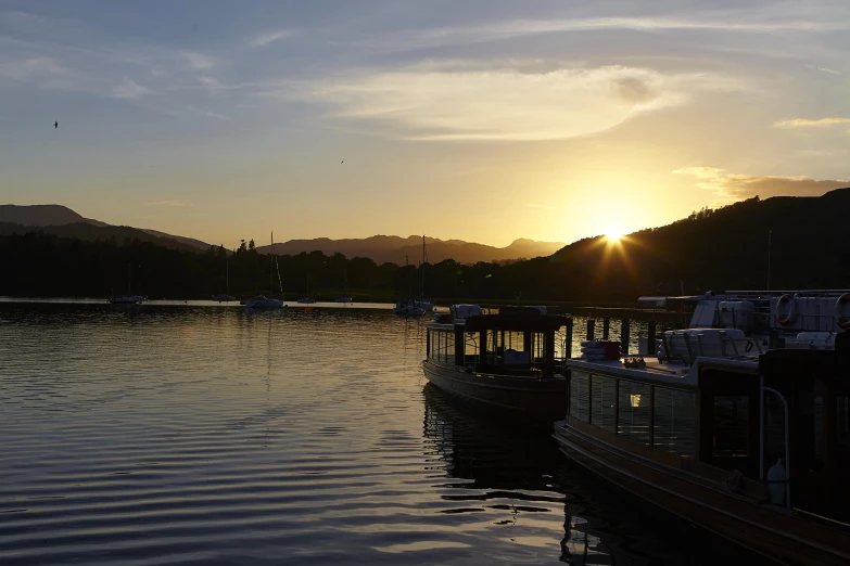 two boats floating in a body of water near a lake