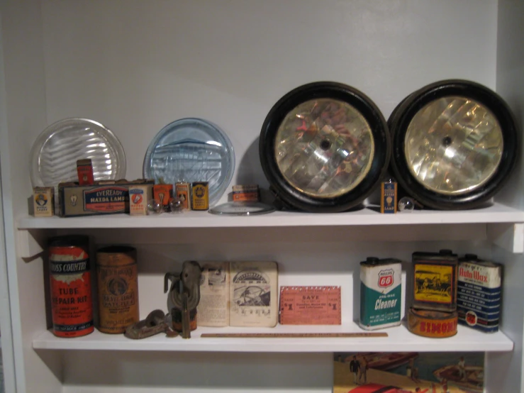 a set of two old fashioned lamps on a white shelf