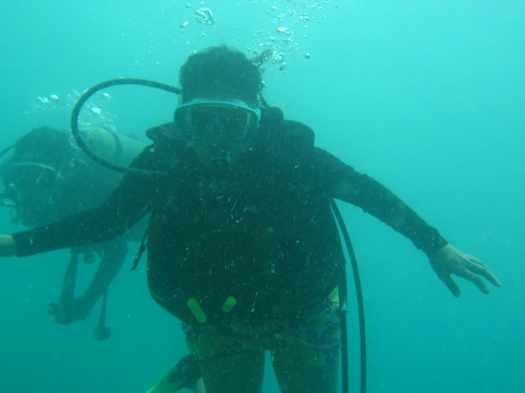 two scuba divers in the water with their equipment