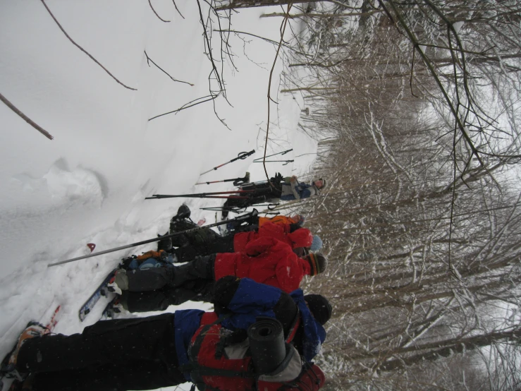 a group of people wearing skis standing around