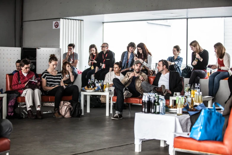 a group of people in a lounge room having a conversation