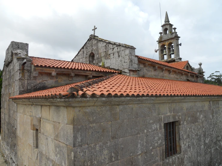 old, gray building with two towers and a steeple