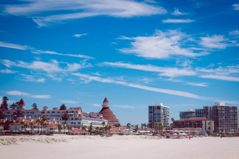 the beach is full of buildings with cars parked on it