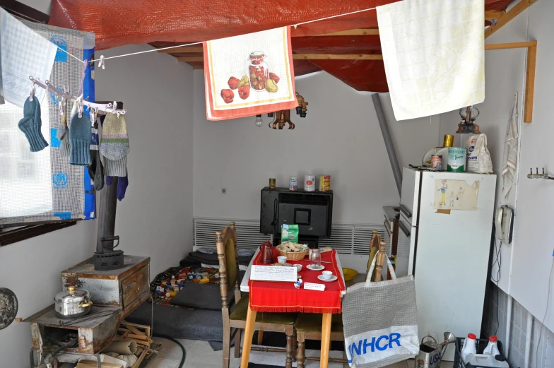 the dining area features many small tables, a stove, and some small chairs