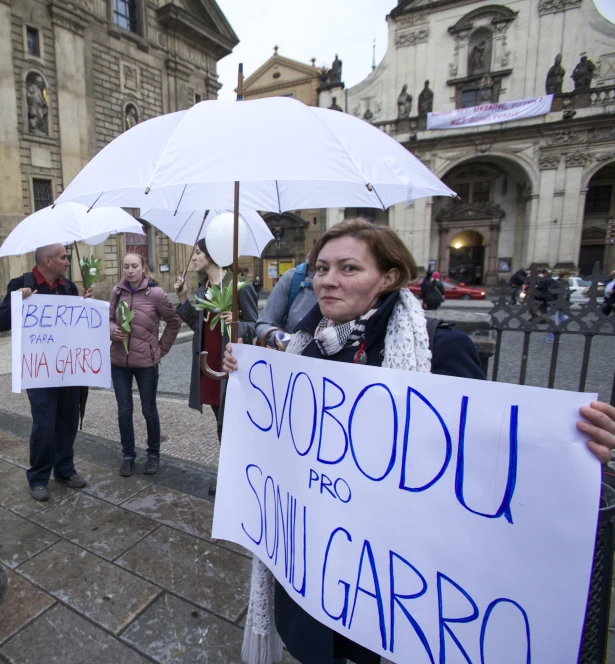 people stand together and hold up signs that say shobodu, smile, garro