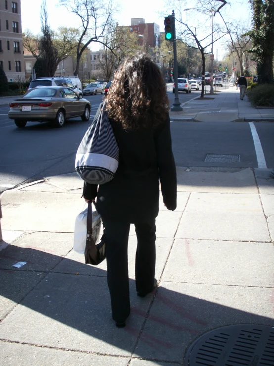 a person walking down the street holding a bag