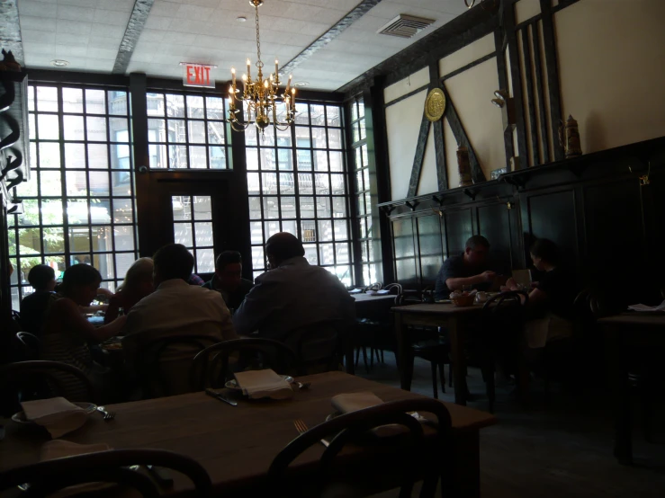 a group of people sitting around a restaurant