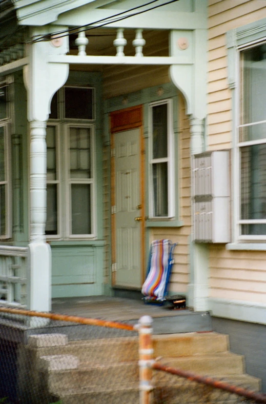 a striped chair is sitting in front of a building