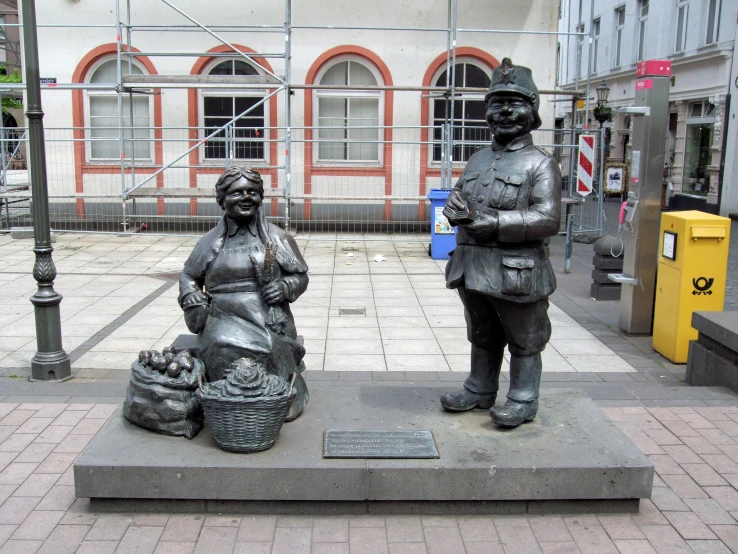 two statues on the ground next to each other