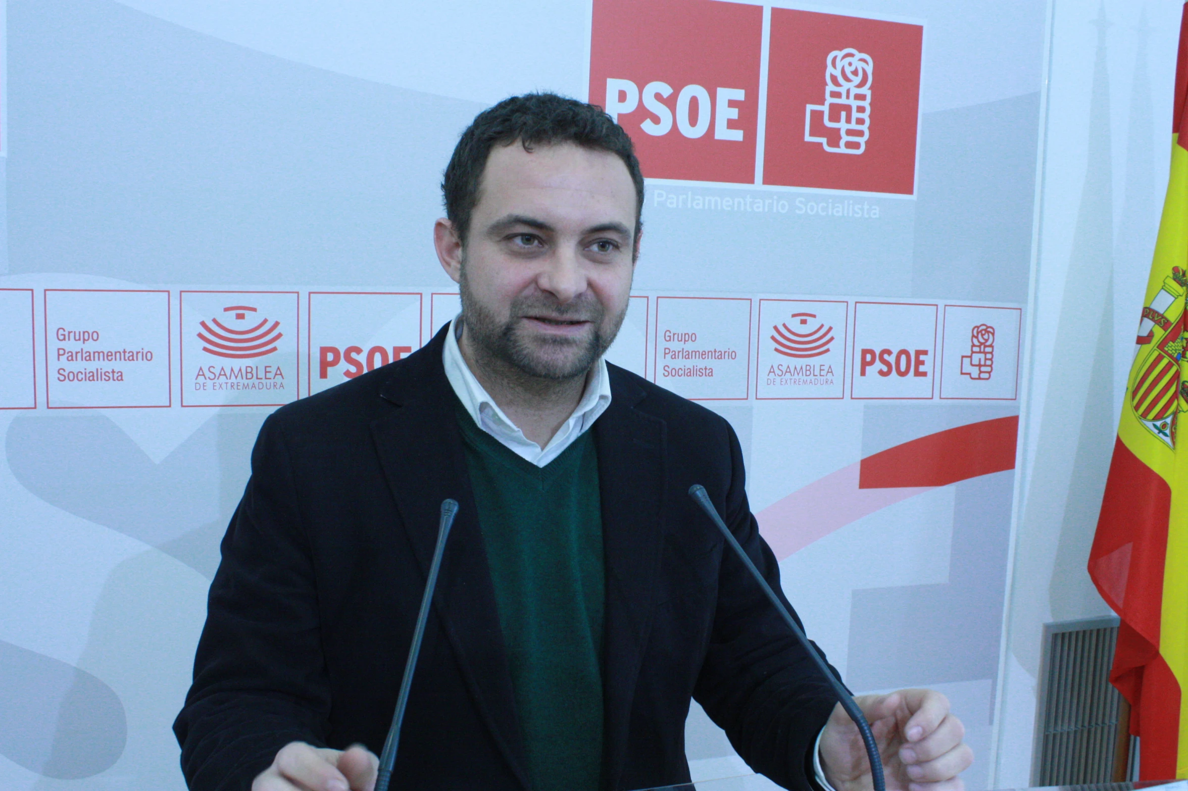 a man standing at a podium in front of flags