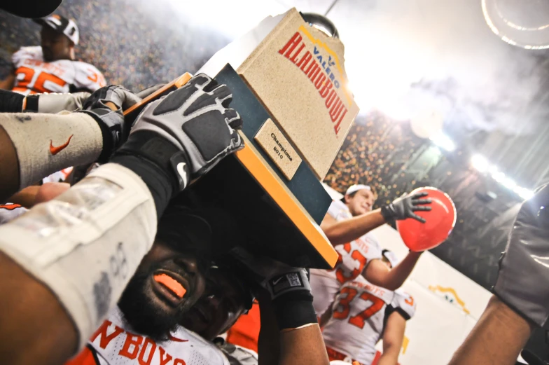 the clemson football team is holding up the big box