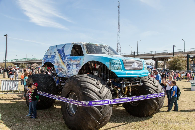 an oversized monster truck is being displayed at an outdoor event