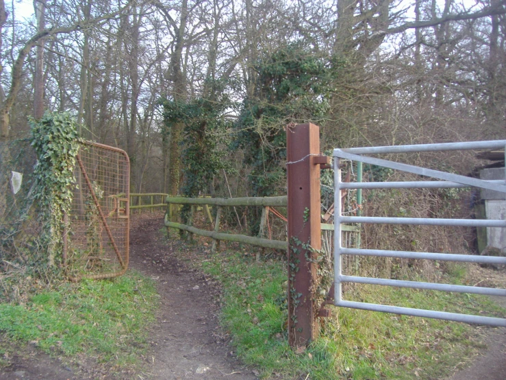 there is an old gate and a wooden gate behind it