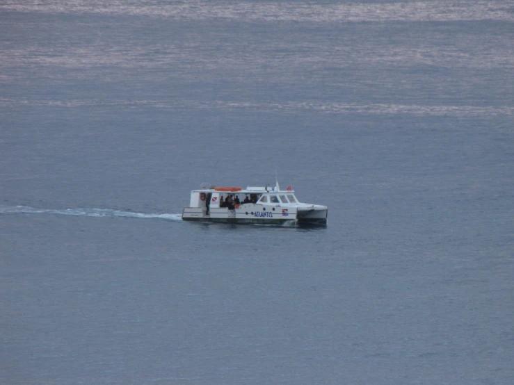 small motor boat traveling across a body of water