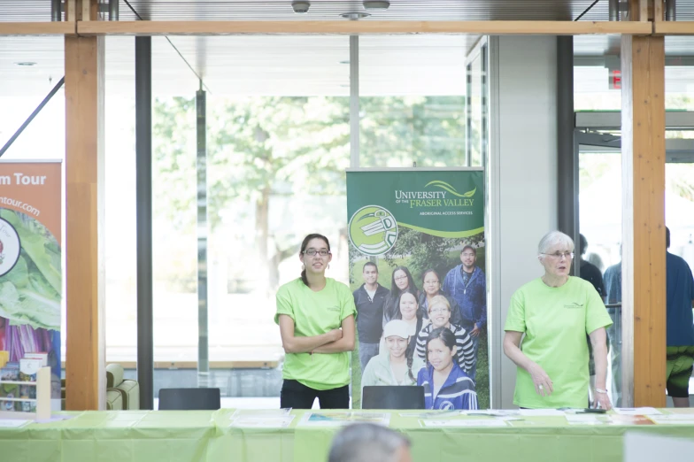 a table has three green people at it