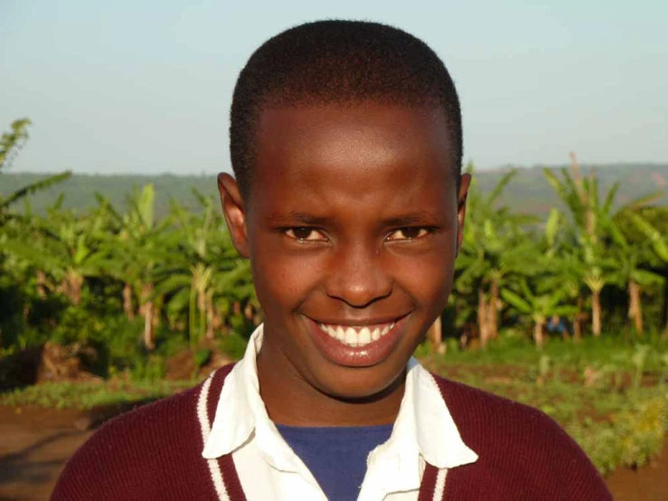 an african boy is smiling at the camera