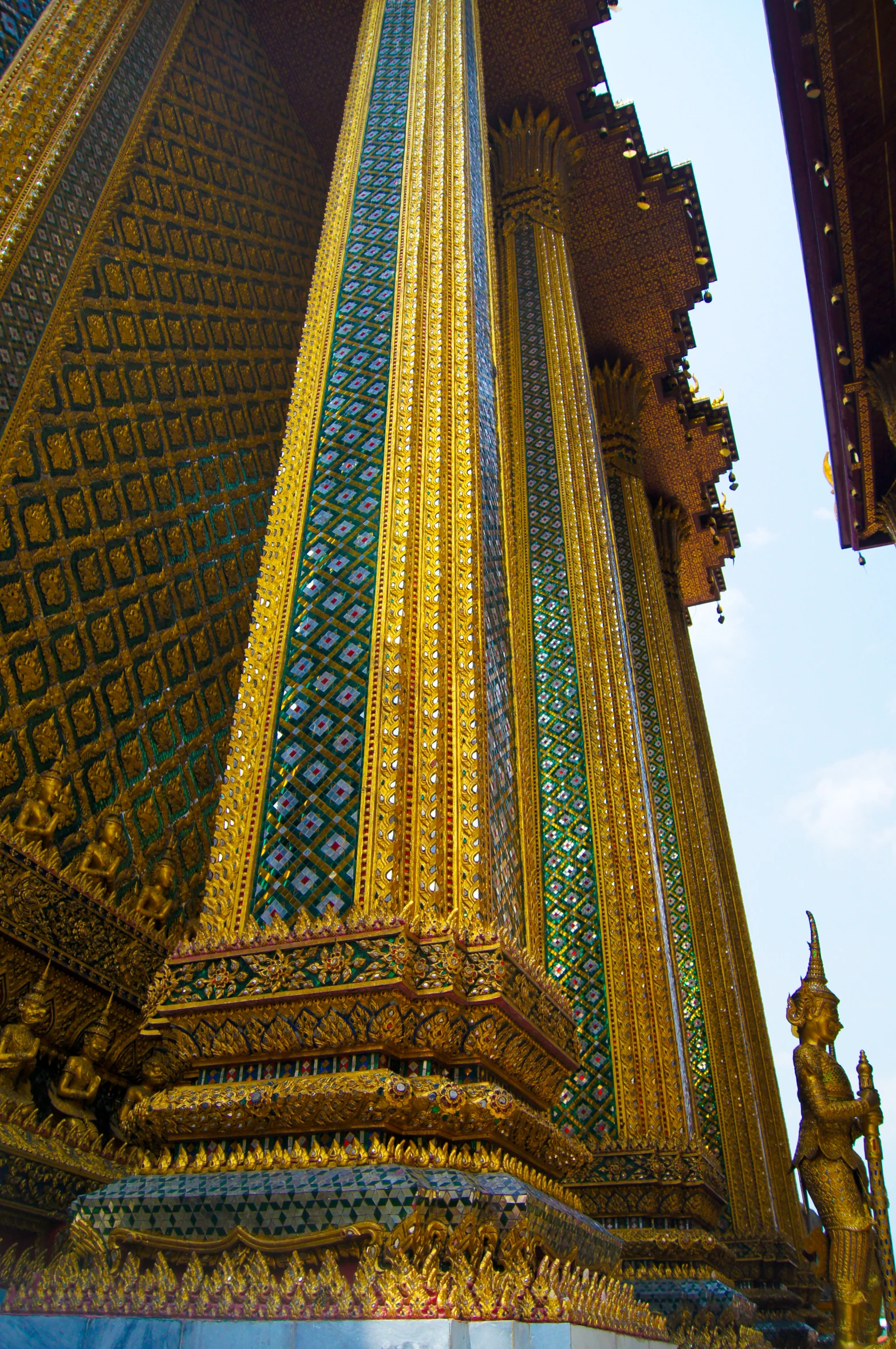 a tall, intricate building with gold, green and blue details