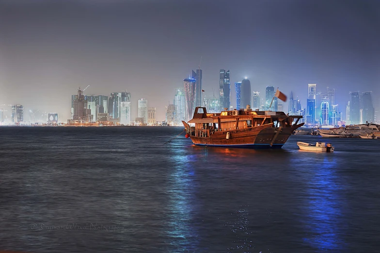 a ship is sailing on the water in front of many buildings