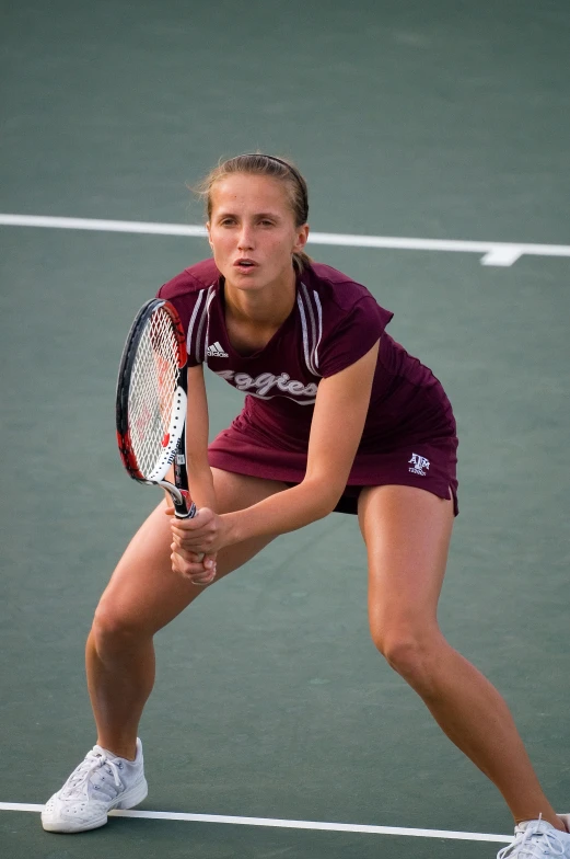 woman tennis player in red dress preparing to serve