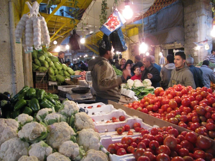 a market has produce and people looking at them