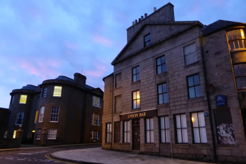 a brick building that is lit up with windows