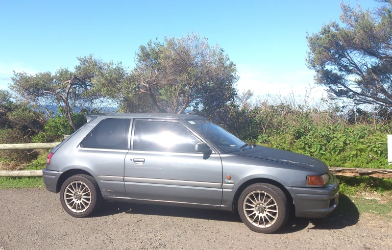 a grey car that is parked in a driveway