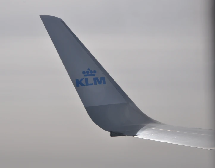 an airplane wing with the klm logo seen from underneath