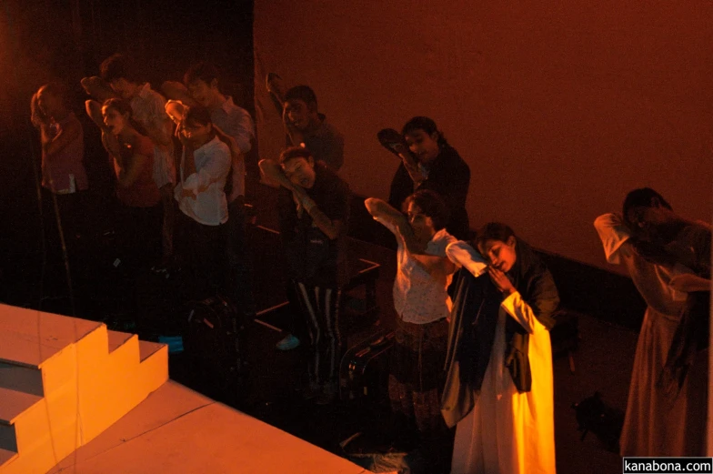 a group of people in a dark room singing