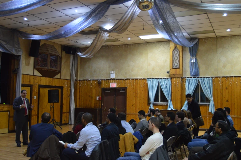 a group of people sitting in a large room