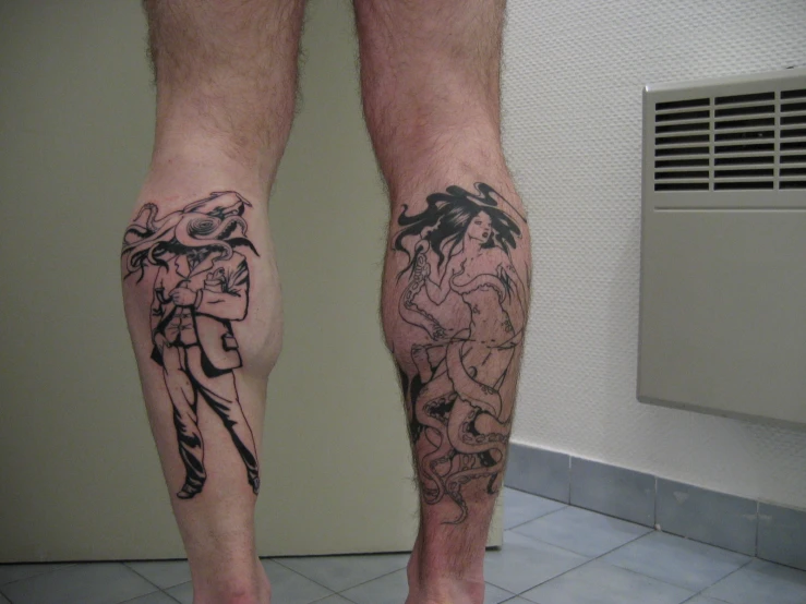 the feet of a person with tattoos on them