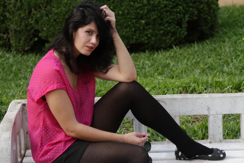 a woman in black tights and a pink top