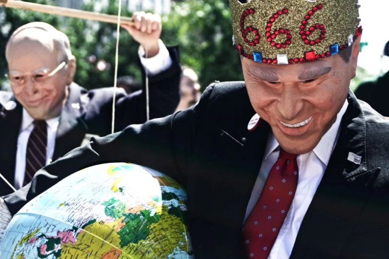 asian man on street with a globe and smiling