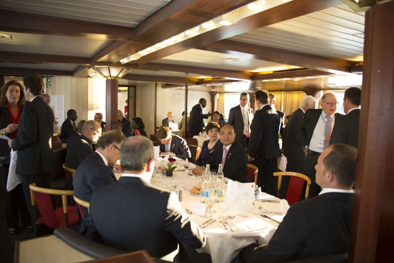 some business people standing in a room eating