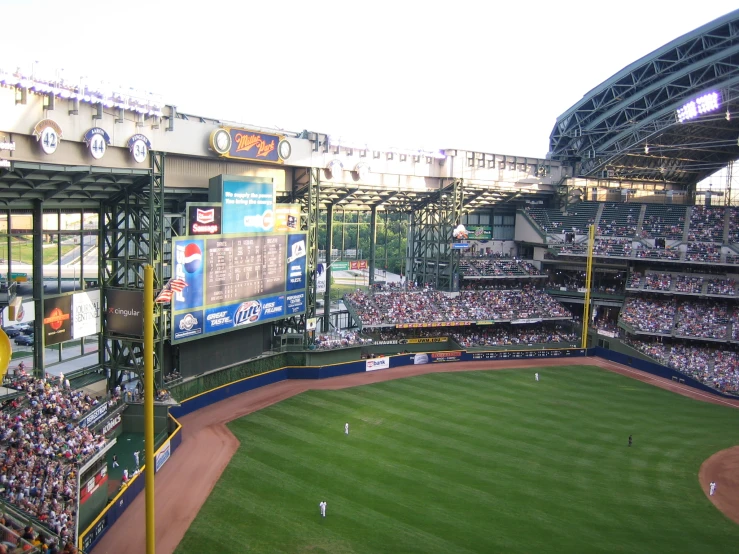 a baseball field is being watched by people