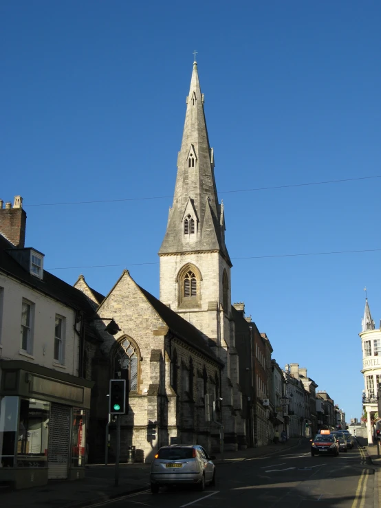 a cathedral like building with several spires towering over a city street