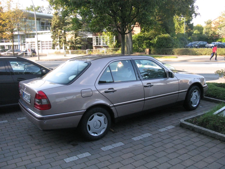 a silver car that is parked near another car