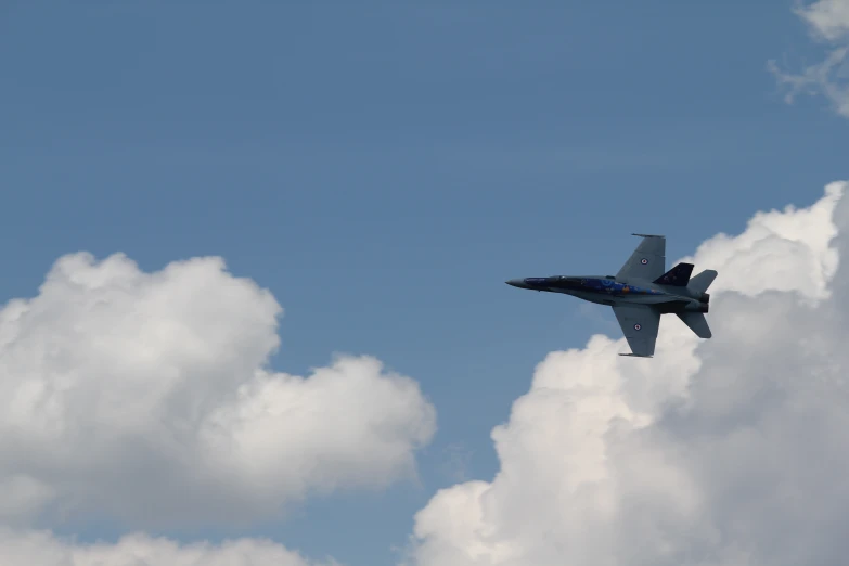 jet in flight in cloudy blue sky and white clouds