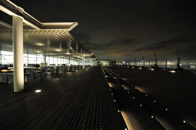 an empty walkway between two buildings at night