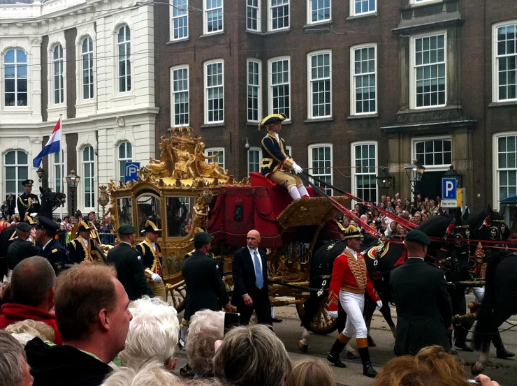 a horse drawn carriage with people surrounding it