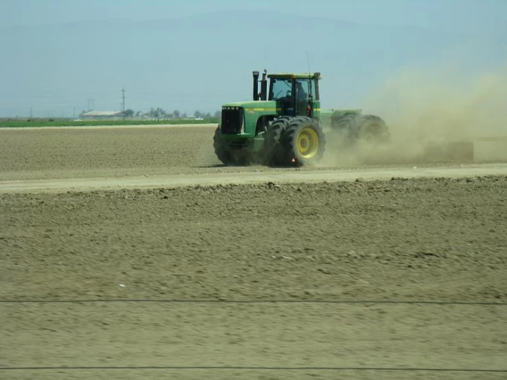 a tractor working in a large open field