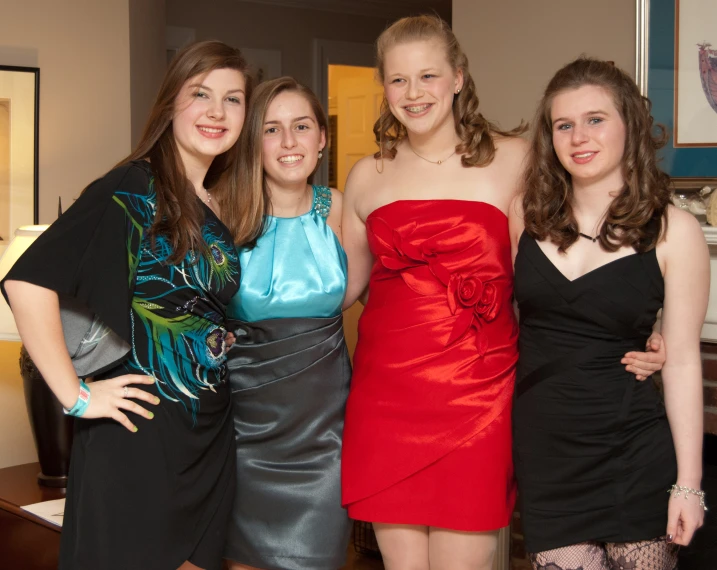 four women in a room posing for a picture