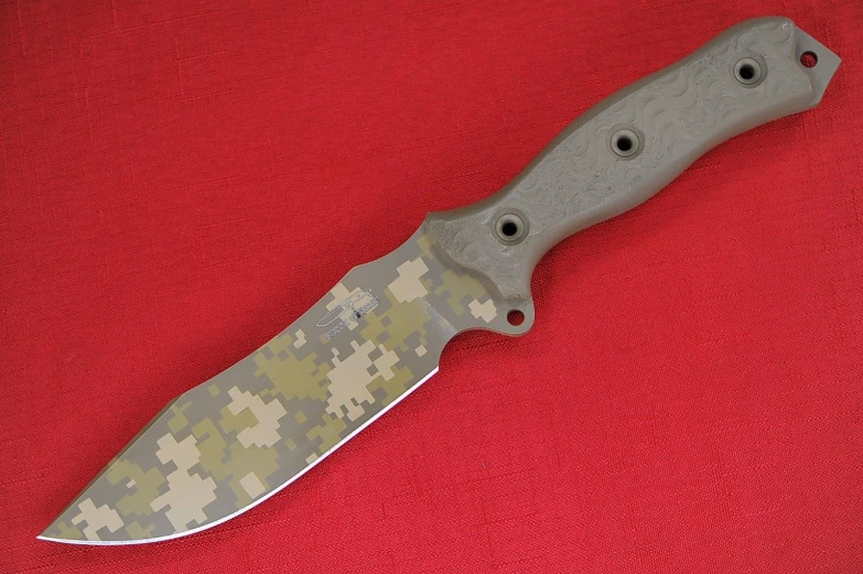 a large knife with a digital camouflage pattern