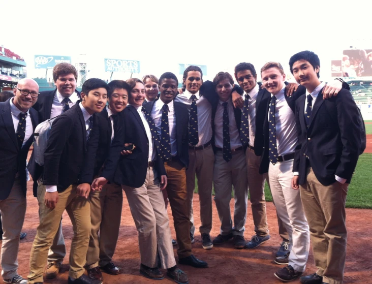 a group of men posing on a baseball field