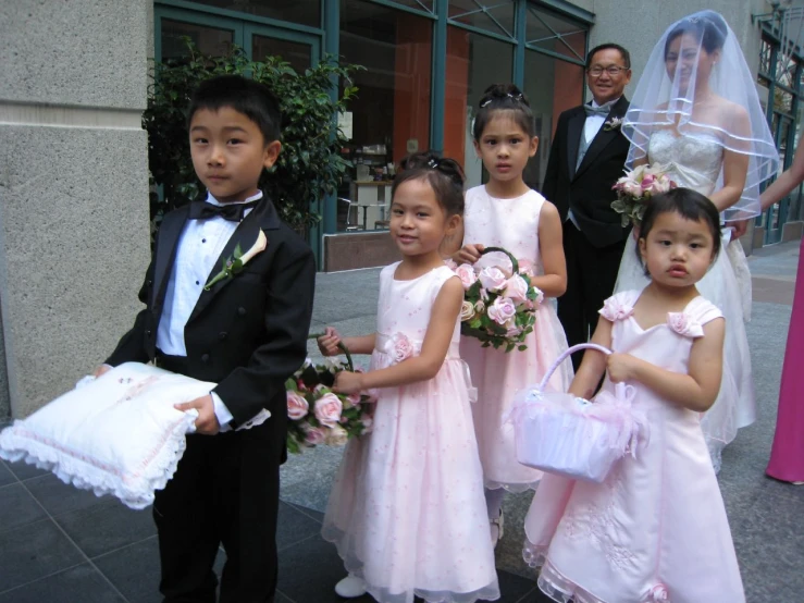 a group of young children dressed up for a wedding