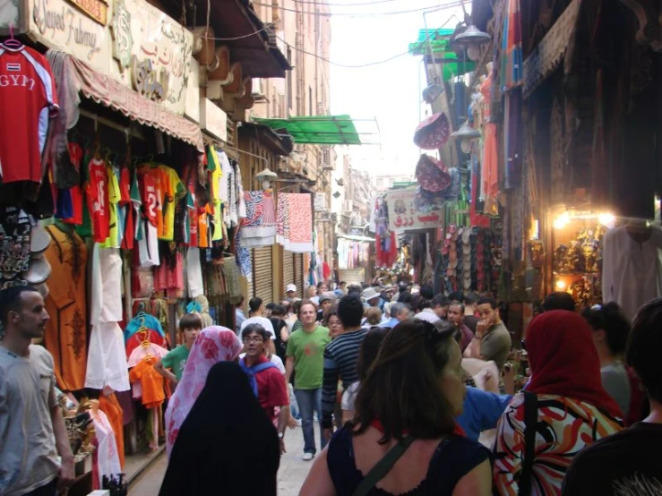 busy street scene with vendors, shops and pedestrians