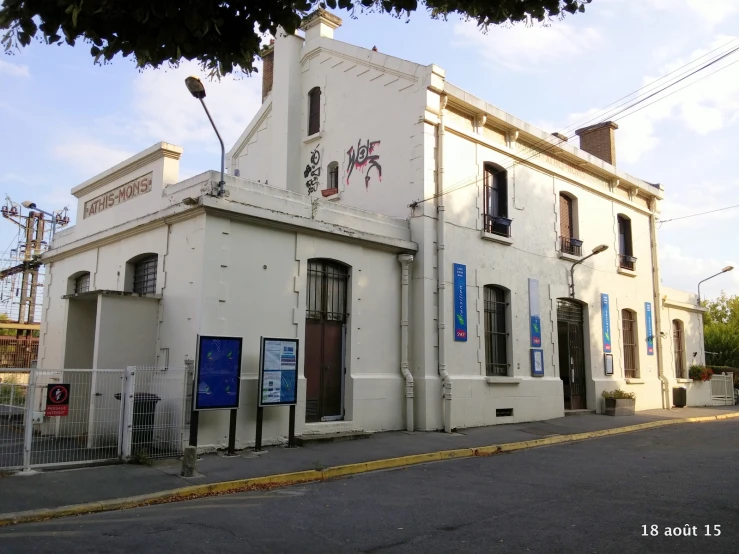 an old building with blue and white signs